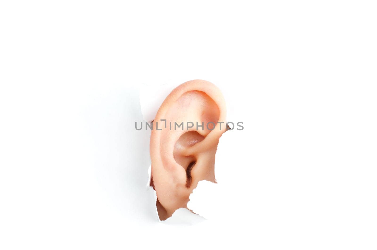 woman ear peeping out from white torn paper