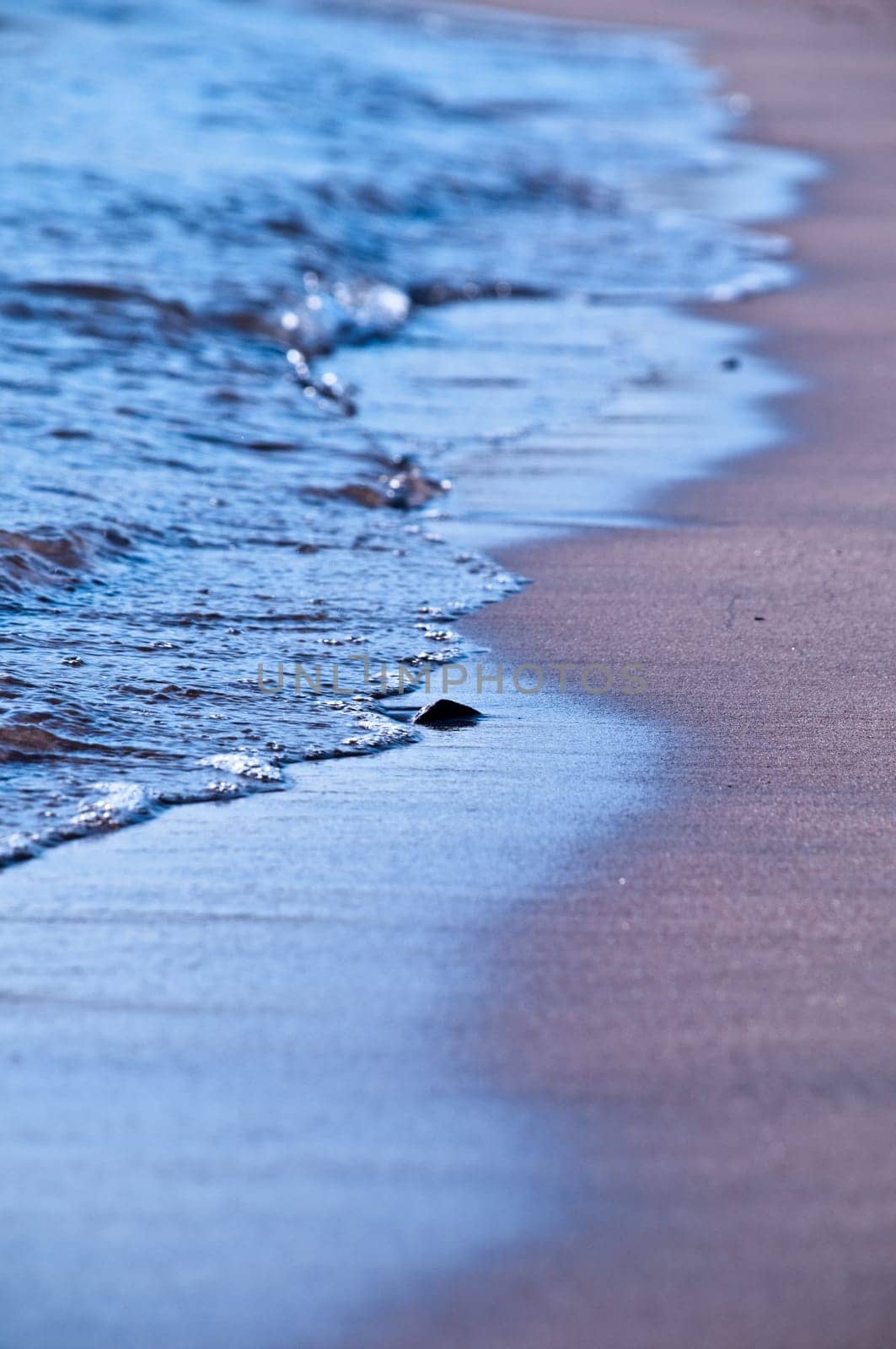 dreamy sea shore with blue waves washing sandy beach