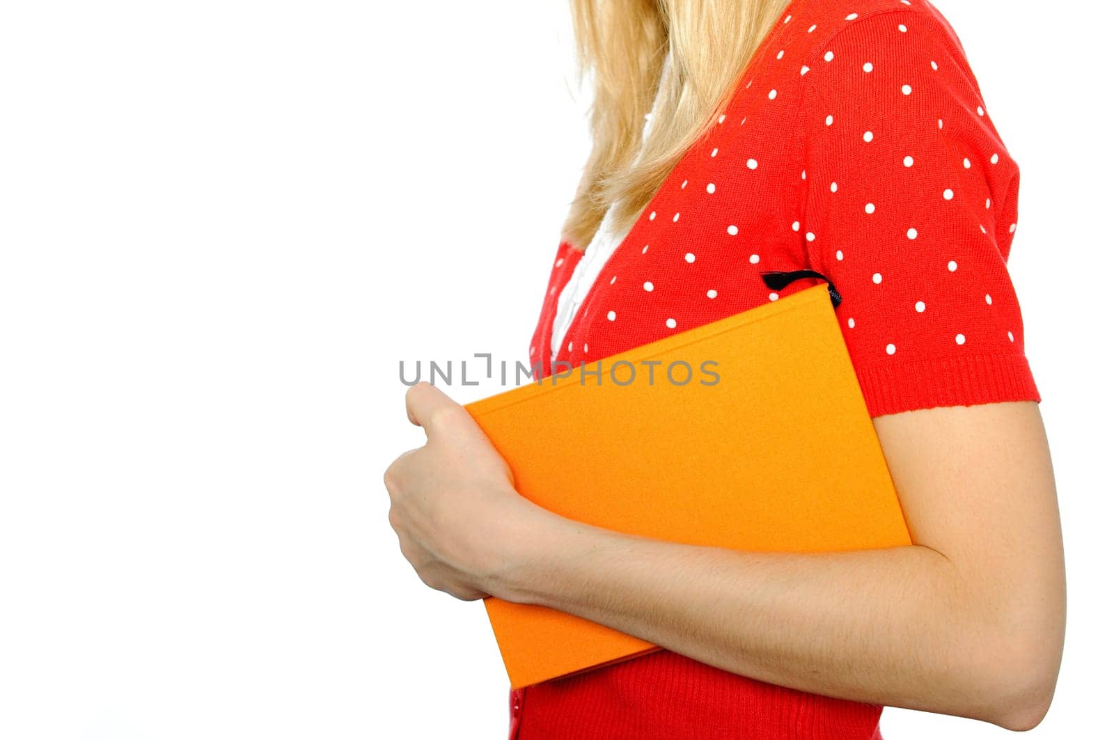 young girl isolated on white background with copy space standing with book in her hand
