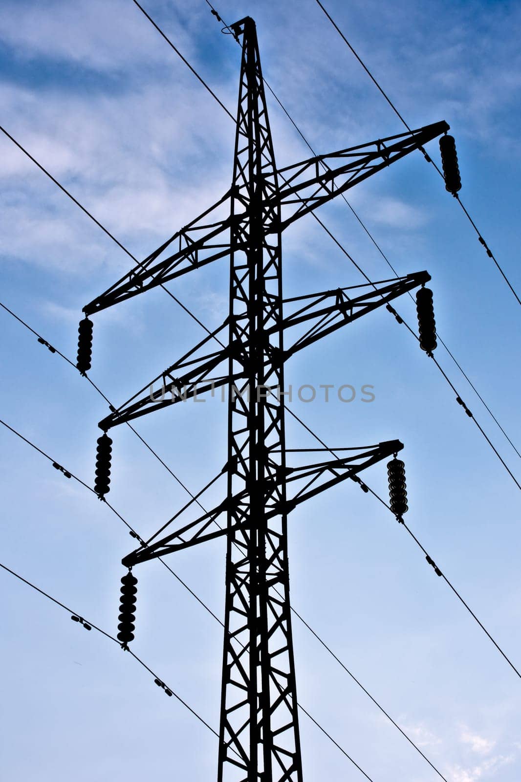 electric transmission line on blue sky background with clouds