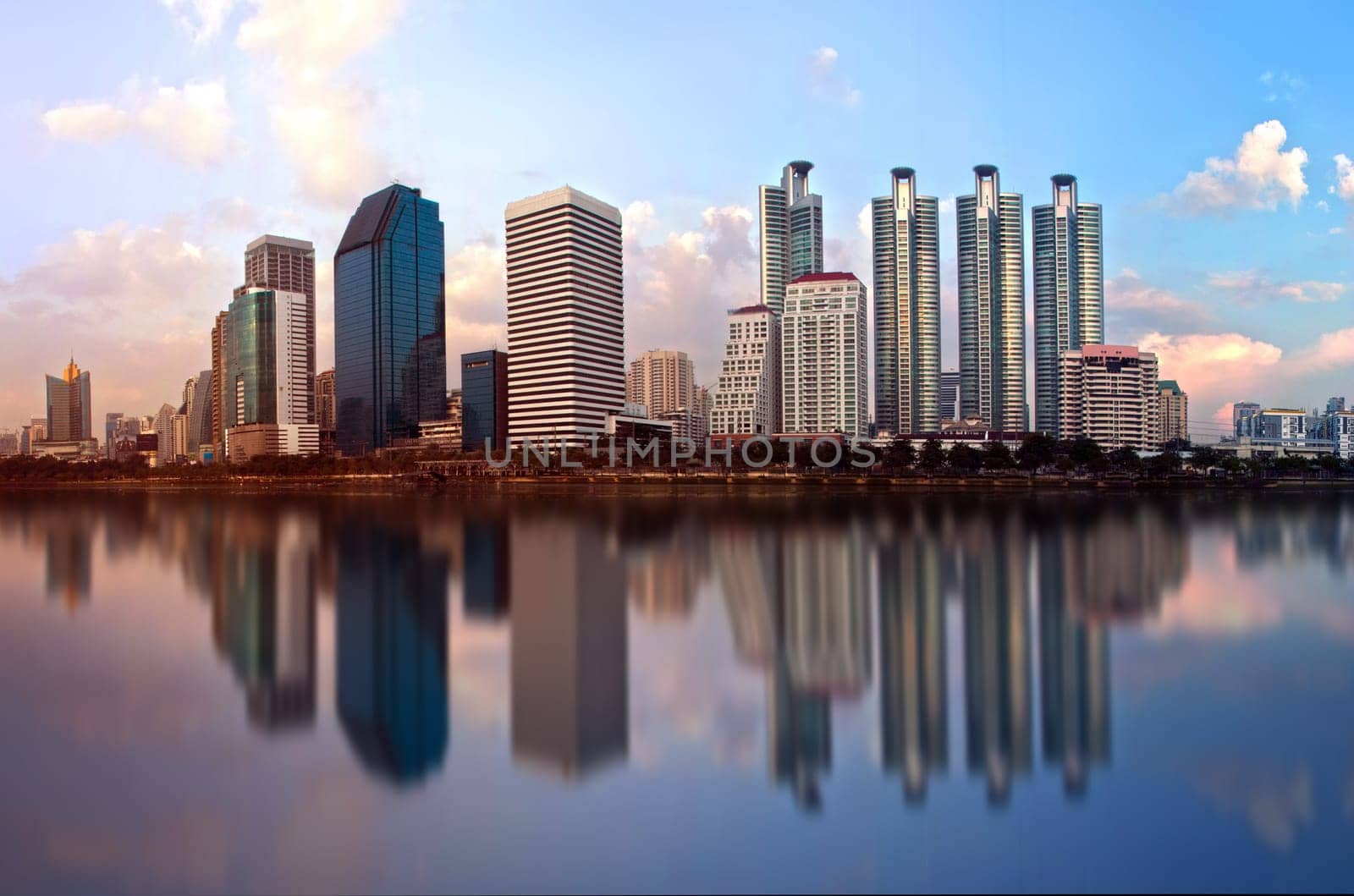 Beautiful city in the morning with a shiny building on the water.