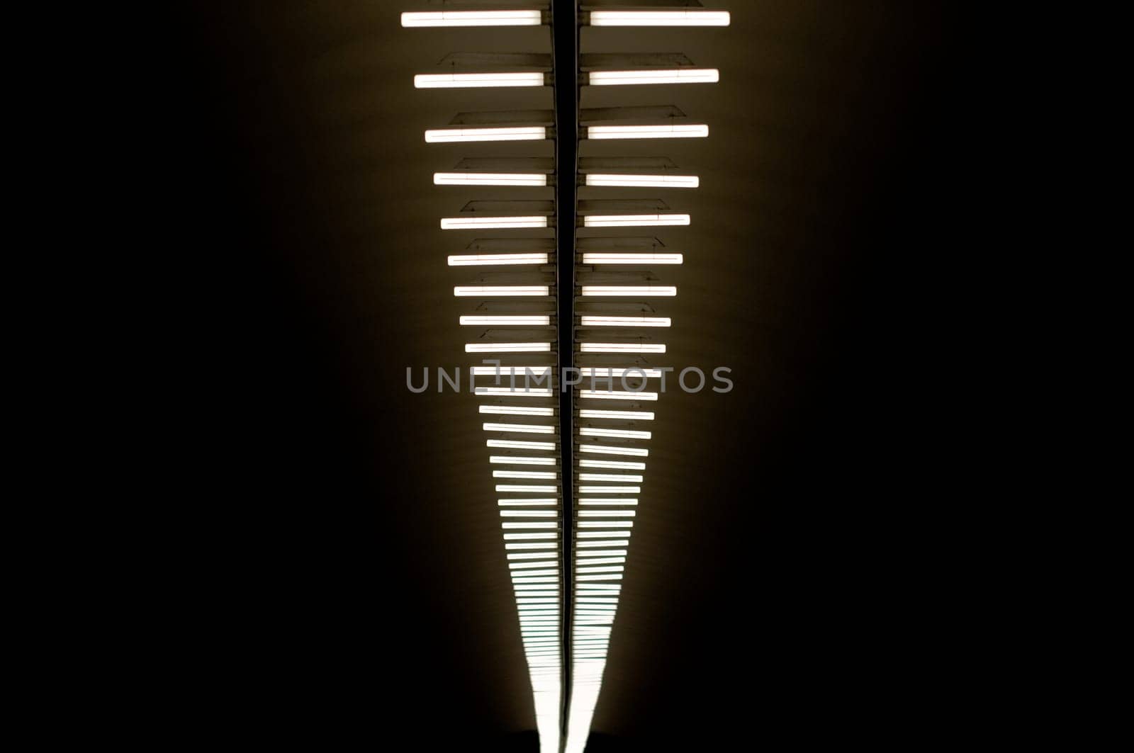 row of lapms on the ceiling of the underground hall