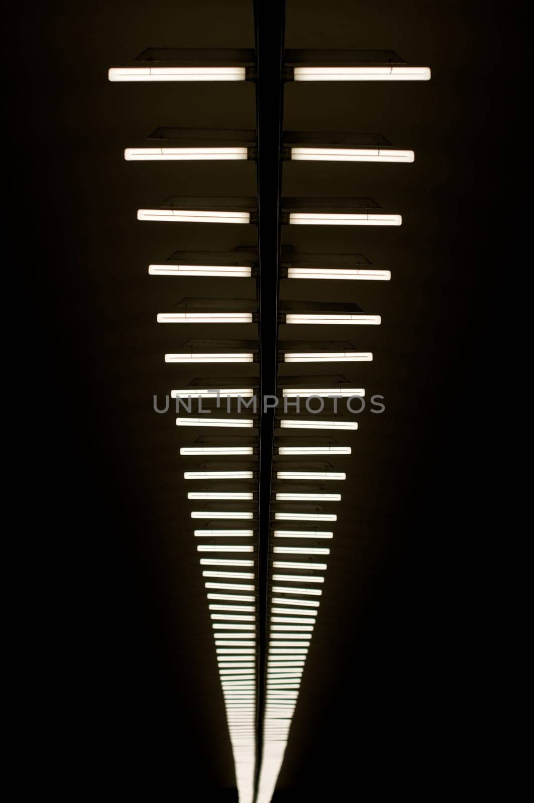 row of lapms on the ceiling of the underground hall