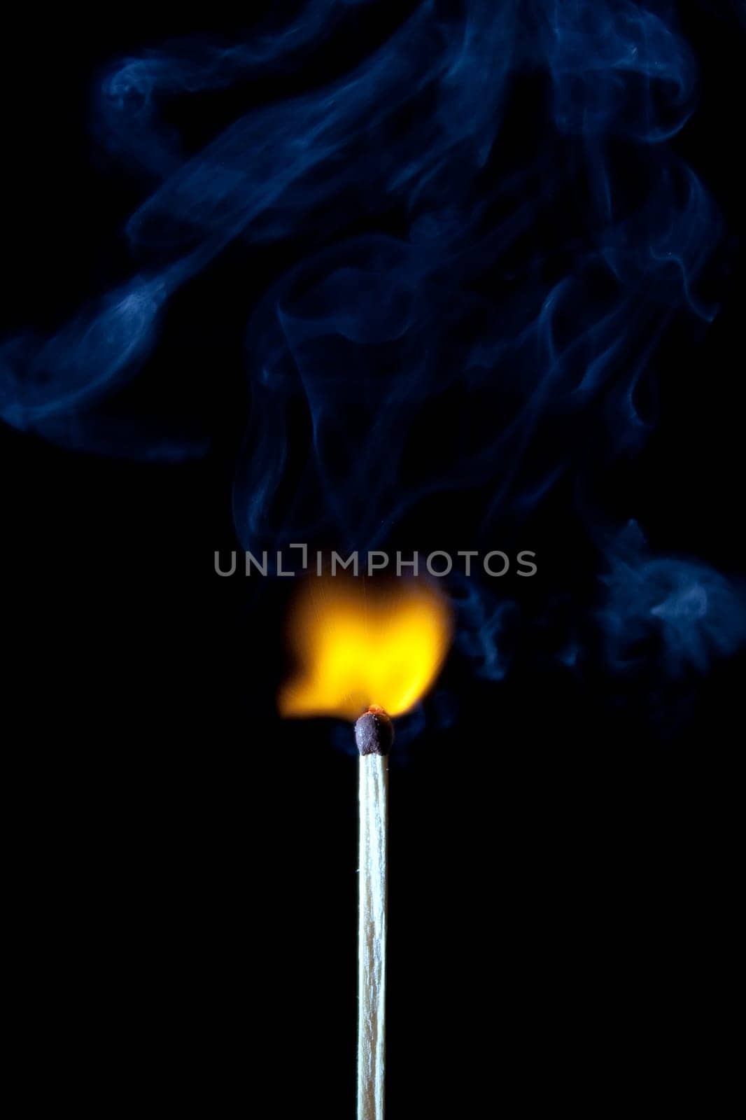 match burning with fire and smoke isolated on black background