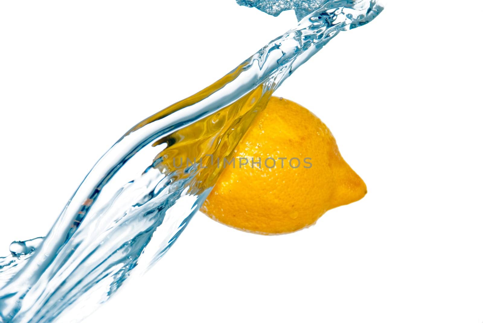 photo of the water washing whole lemon isolated on white