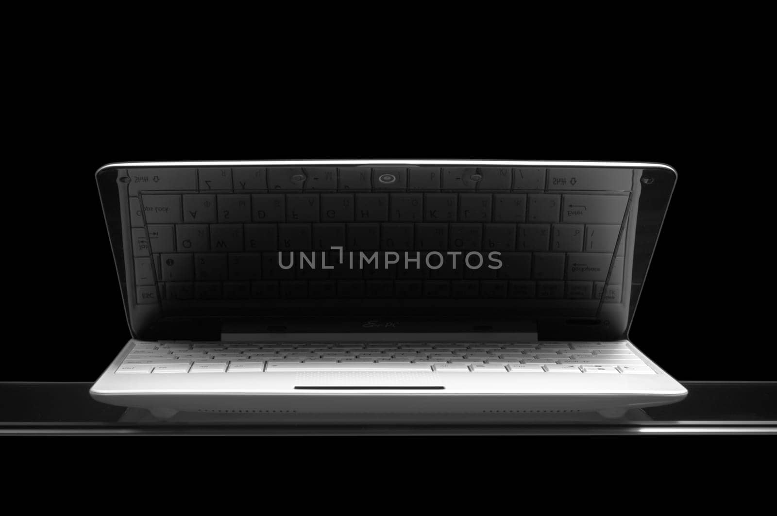 opened white notebook on glass isolated on black background