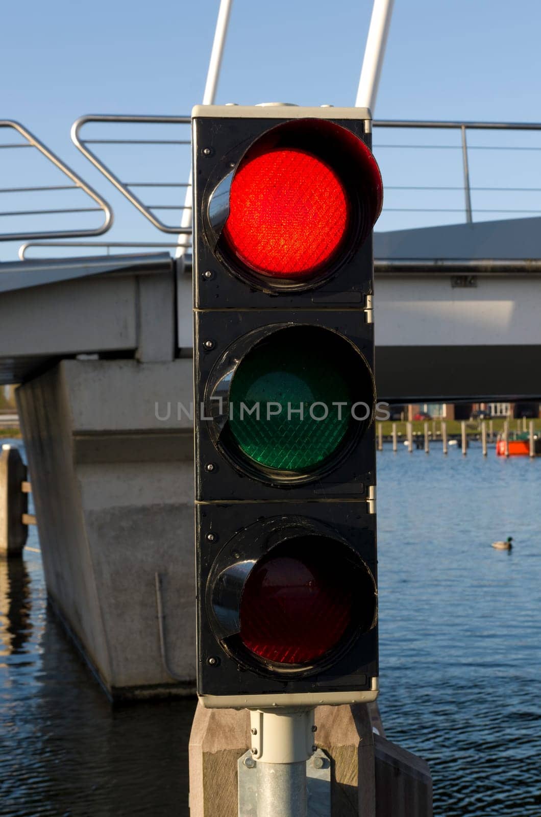 red color on a traffic light in front of a drawbridge