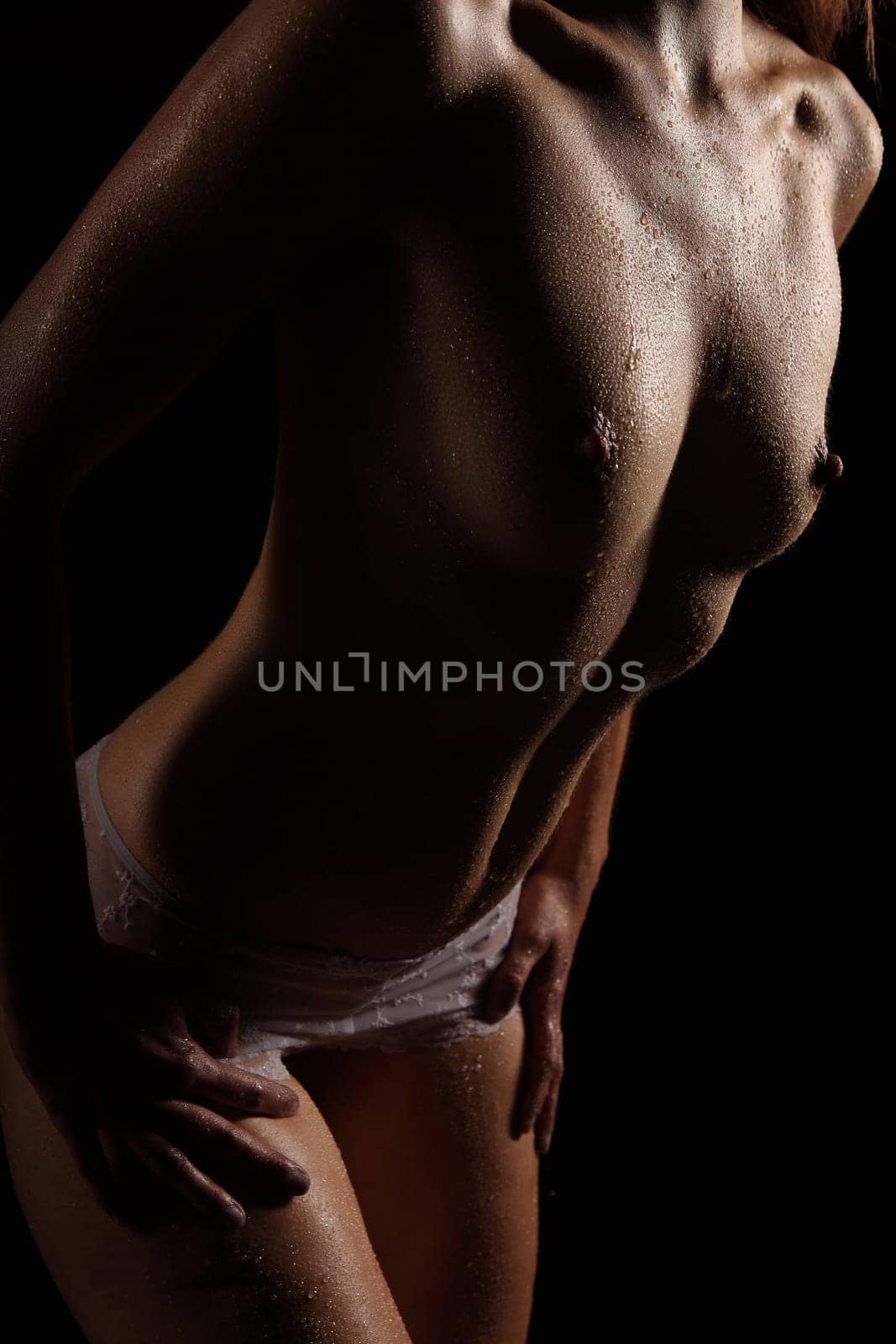Body of a woman covered with drops of water.