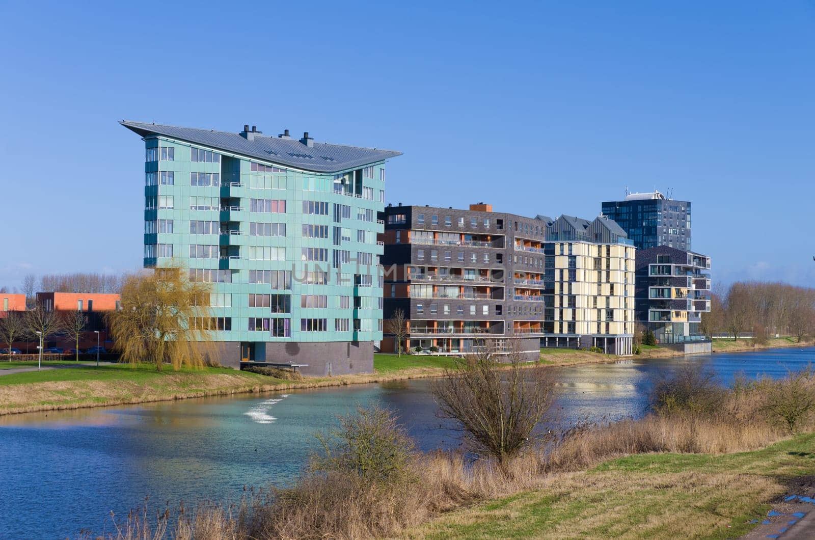 modern apartments along a canal in Almere, Netherlands