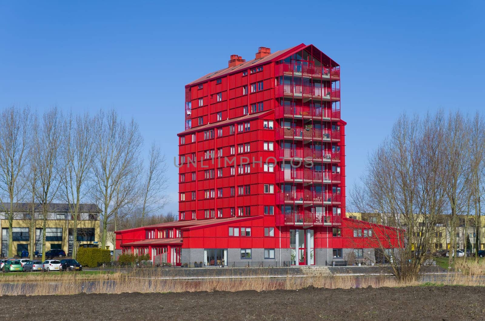 modern red apartment in Almere, Netherlands. They are called "red thunders"" and figuring the transition from the outer residential areas to the agricultural polders"