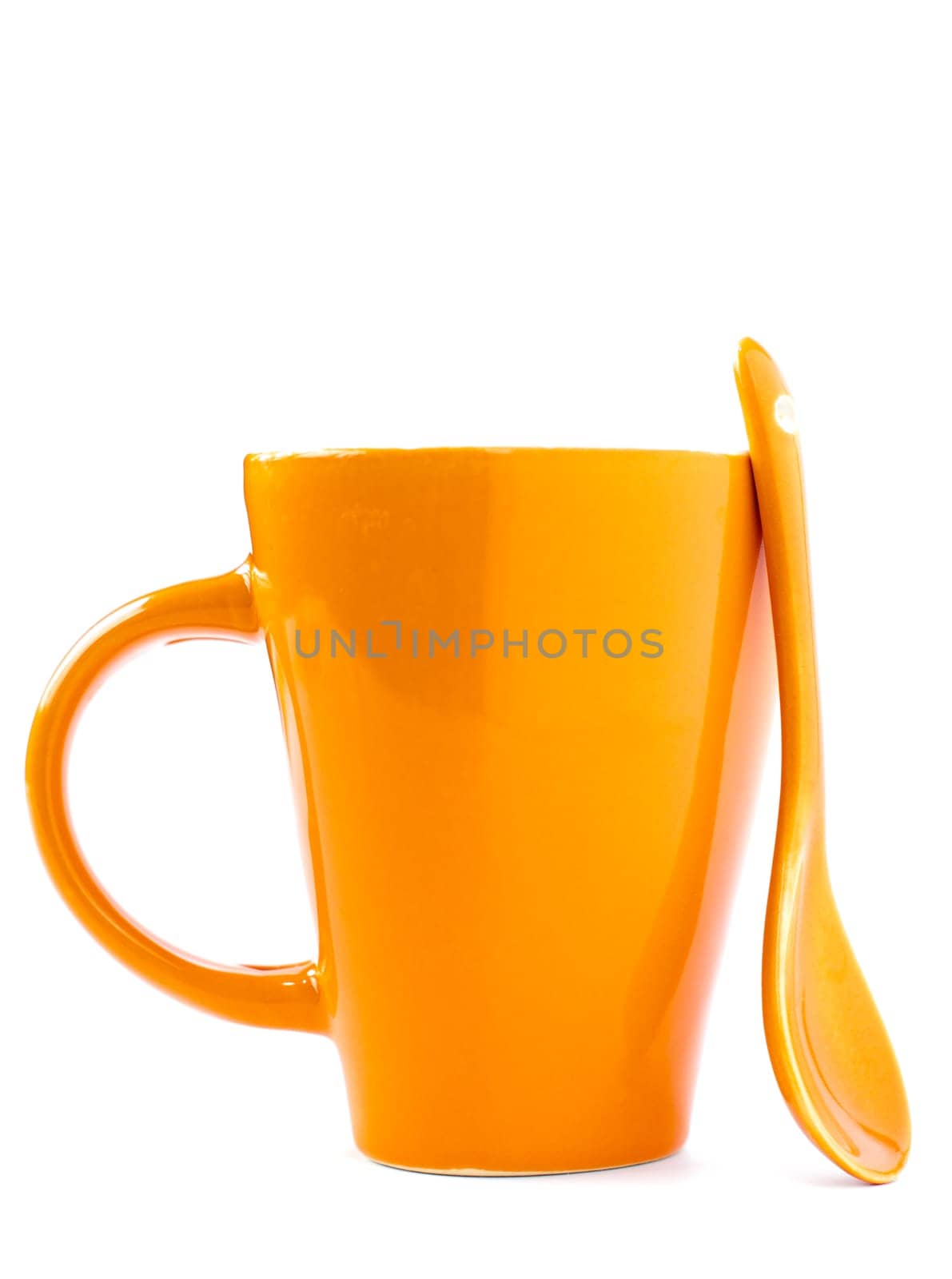 orange empty ceramic cup and spoon isolated on white