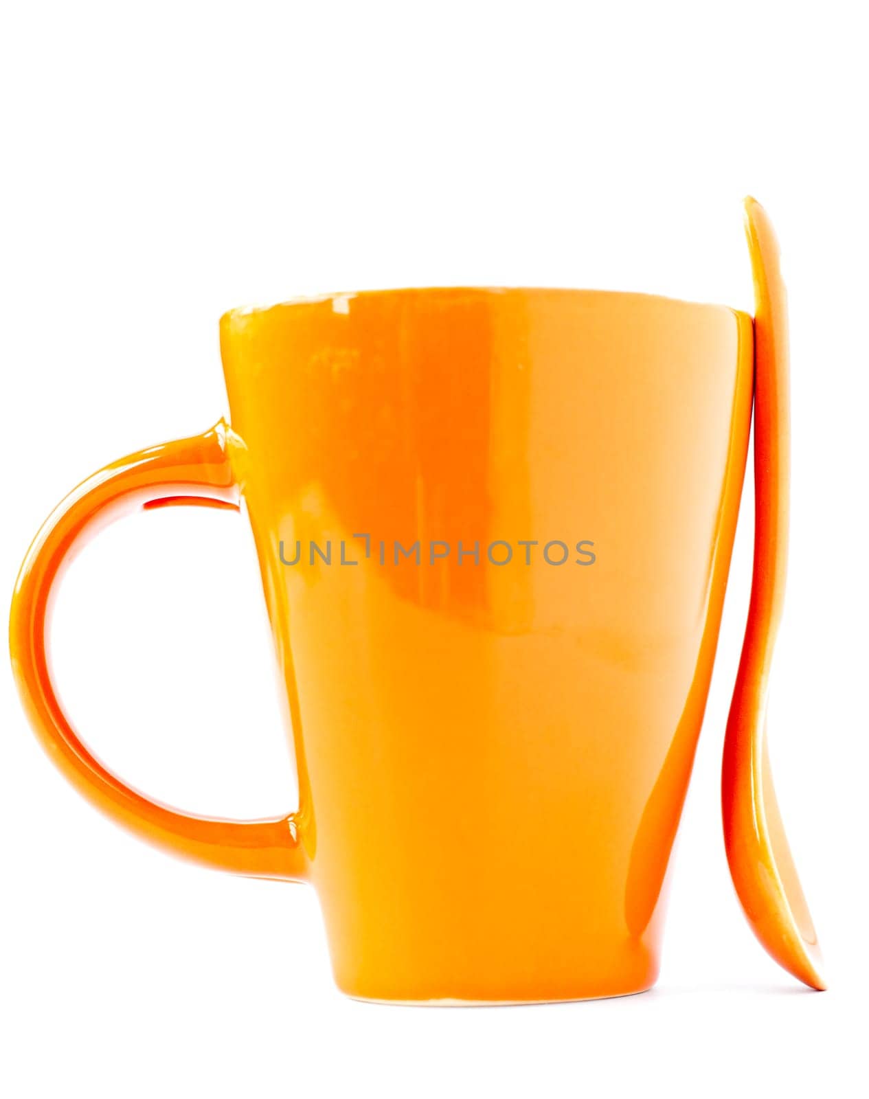 orange empty ceramic cup and spoon isolated on white