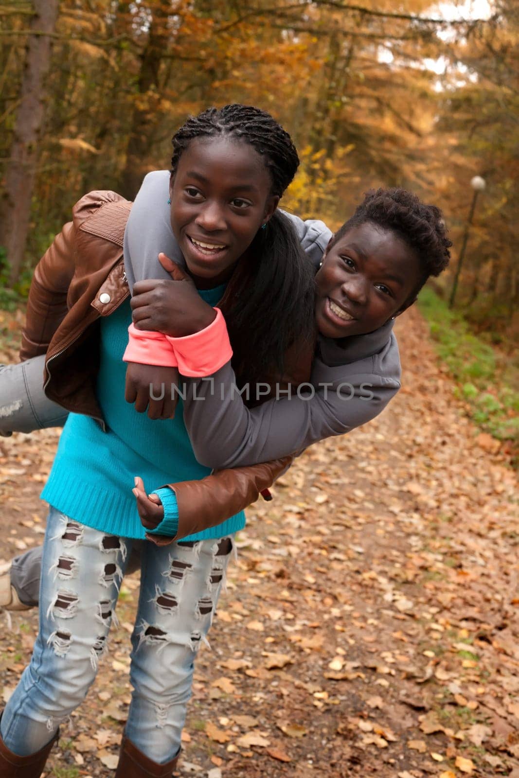 Happy girls in the forest are having fun