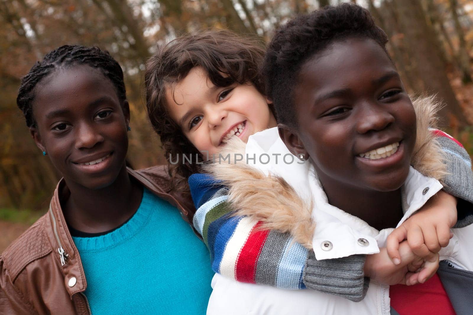 Happy foster children in the forest are having fun