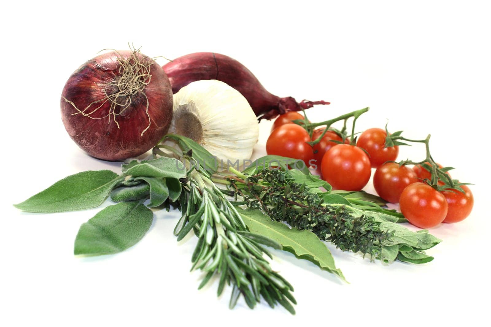 Various herbs and vegetables against white background