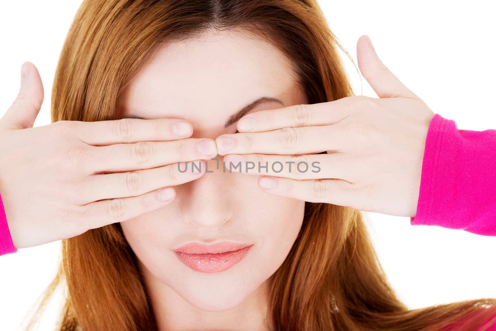 Woman covering eyes with her hands over white background