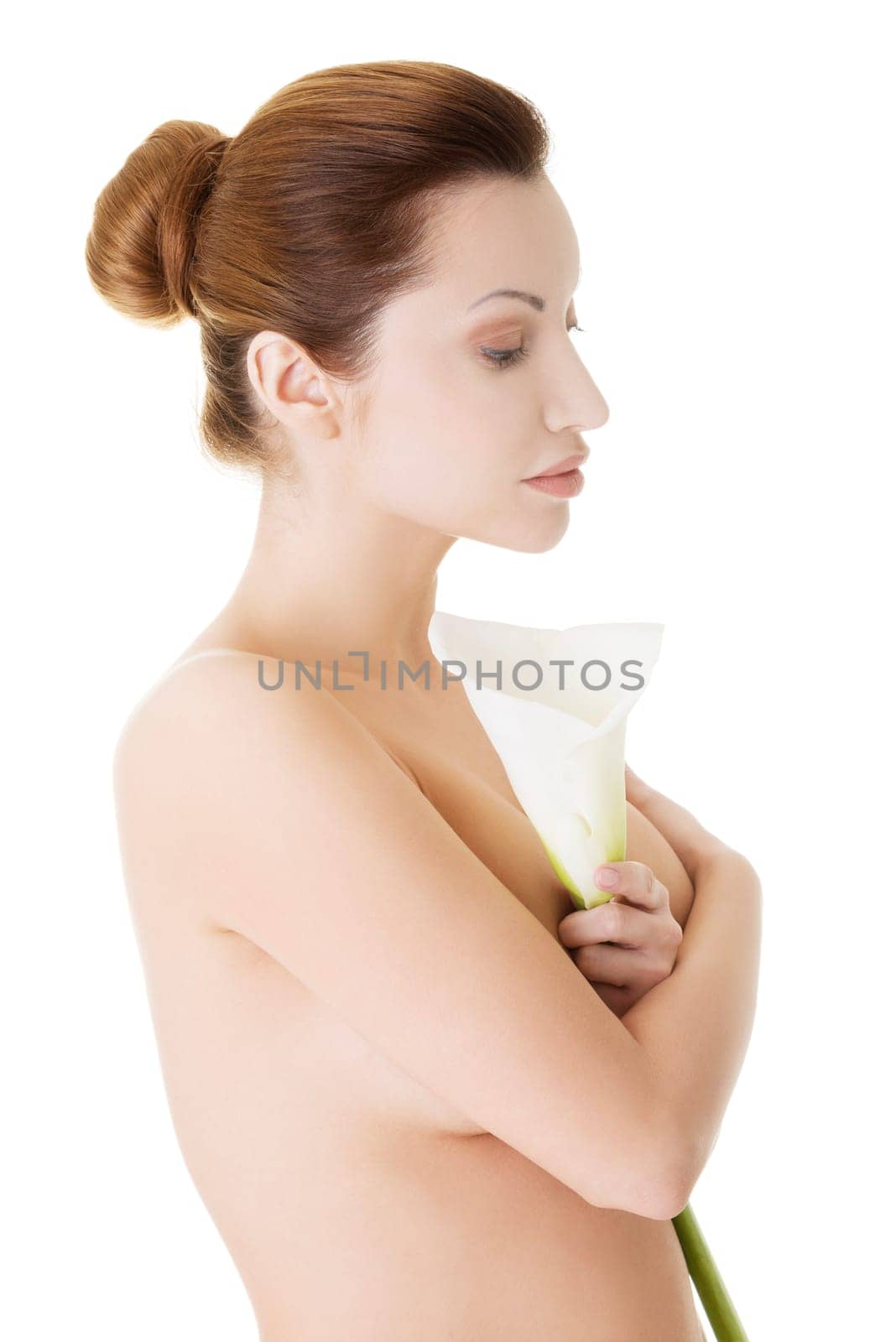 Portrait of beautiful adult woman with health skin and with calla flower