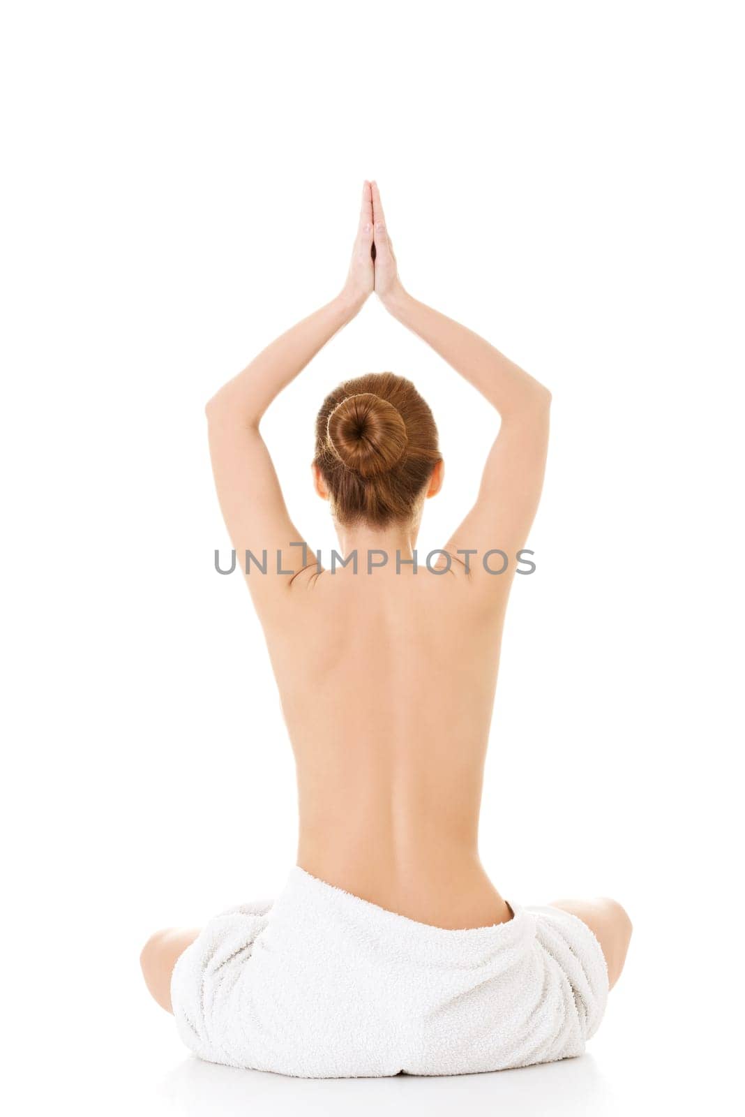 Young beautiful nude woman with towel practicing zoga , isolated on white