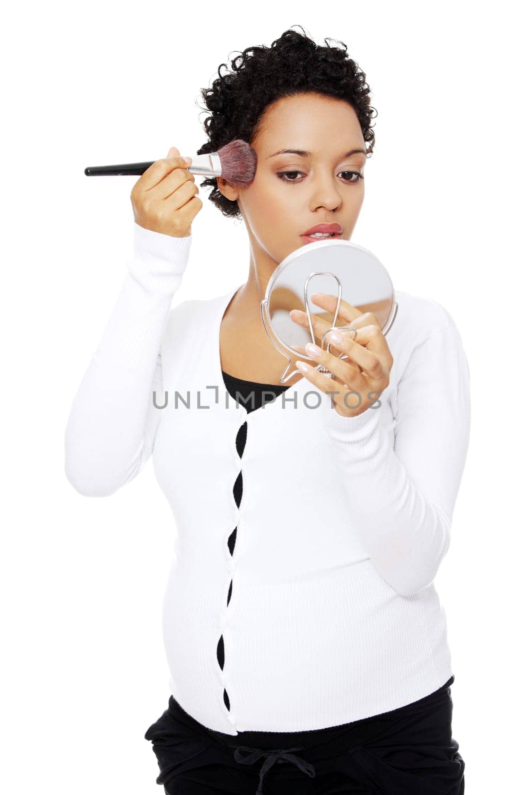 Pregnant woman doing a makeup with make-up brushes. Isolated on white background