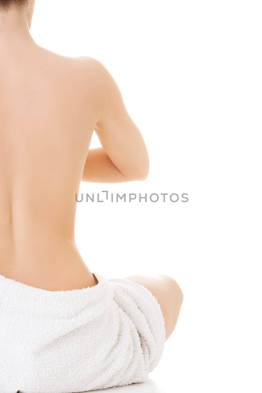 Young beautiful nude woman with towel practicing zoga , isolated on white