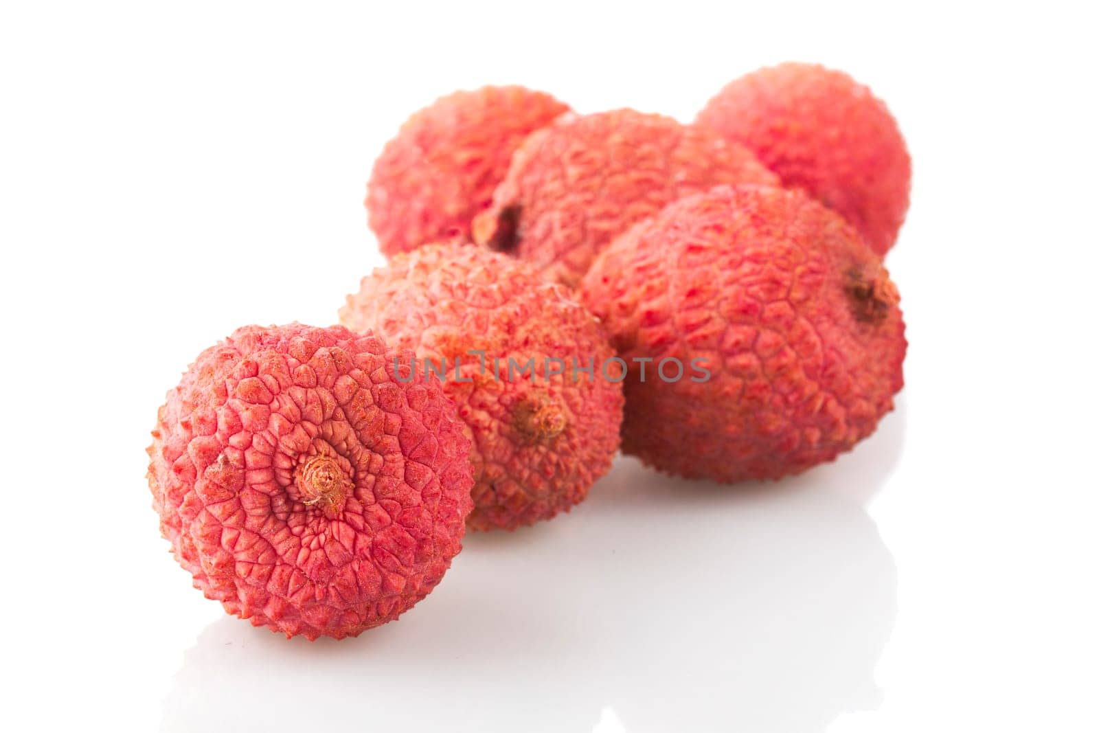 Group of lychee fruit on white with shadows