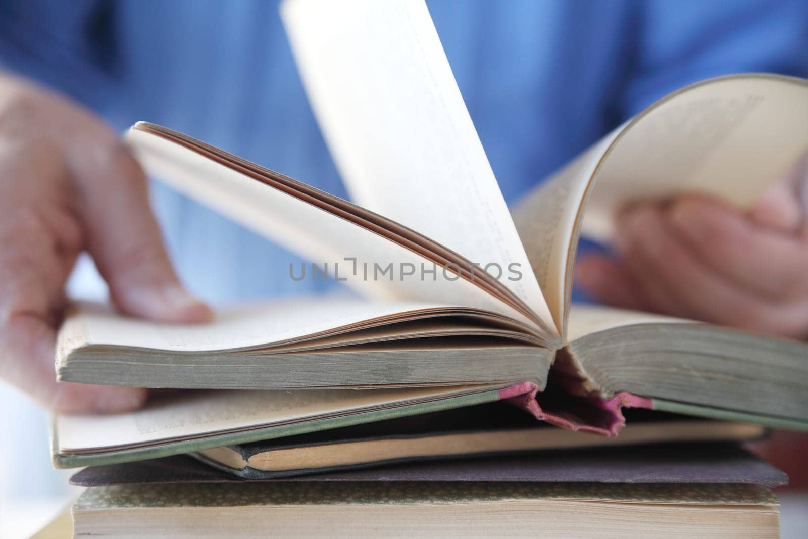 a man flips through the pages of a book
