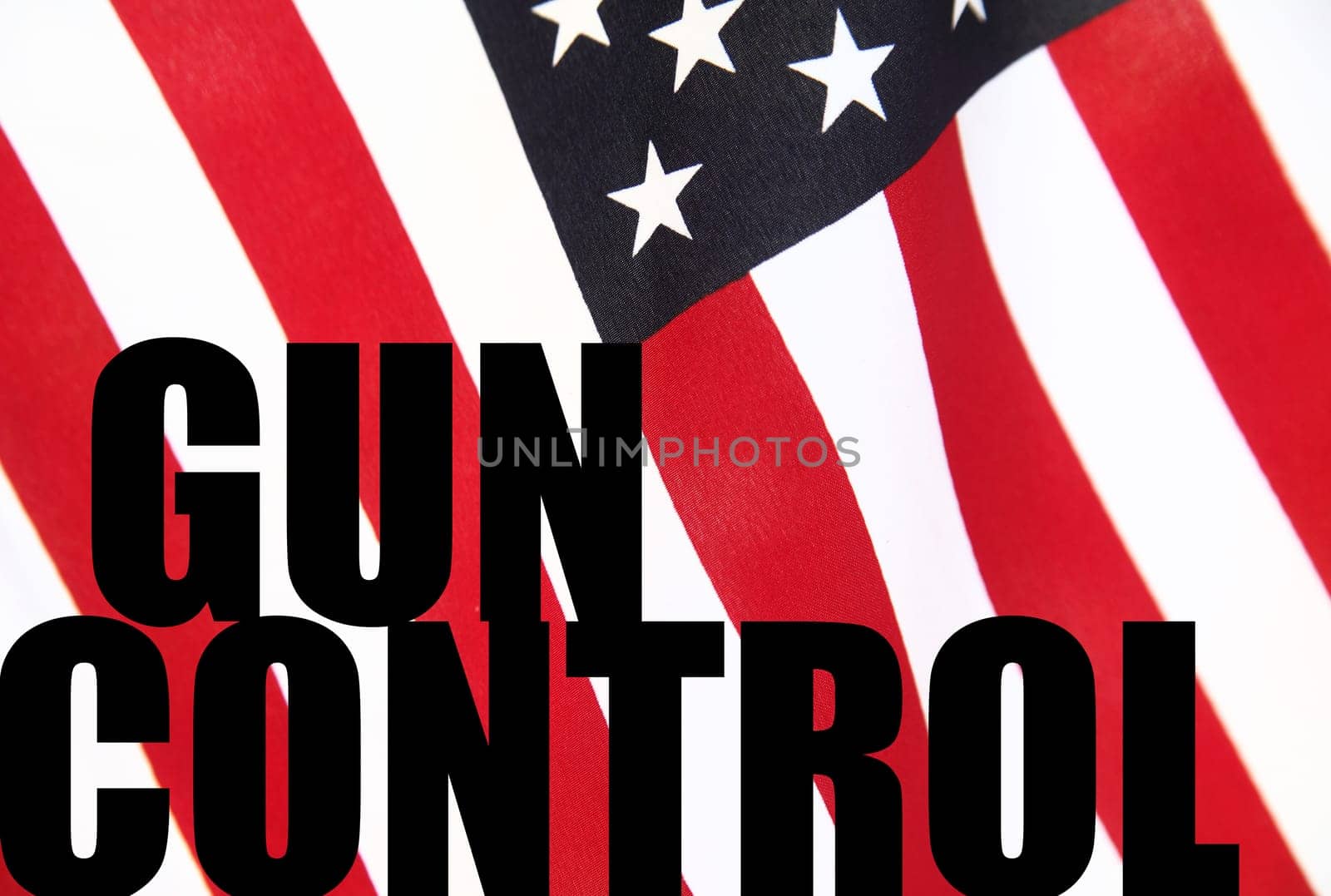 the words gun control on a USA flag background
