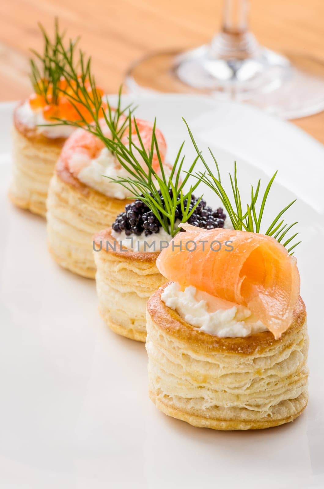Puff pastry pies with salmon,caviar and prawns