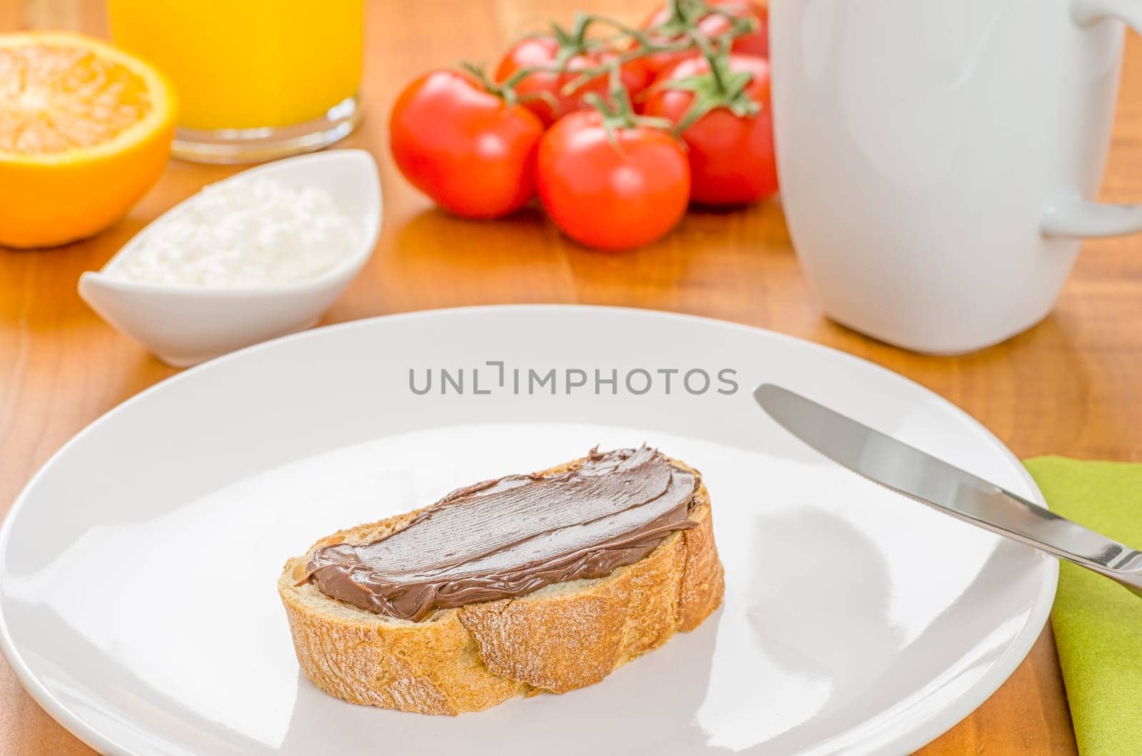 Baguette with hazelnut cream on a set breakfast table