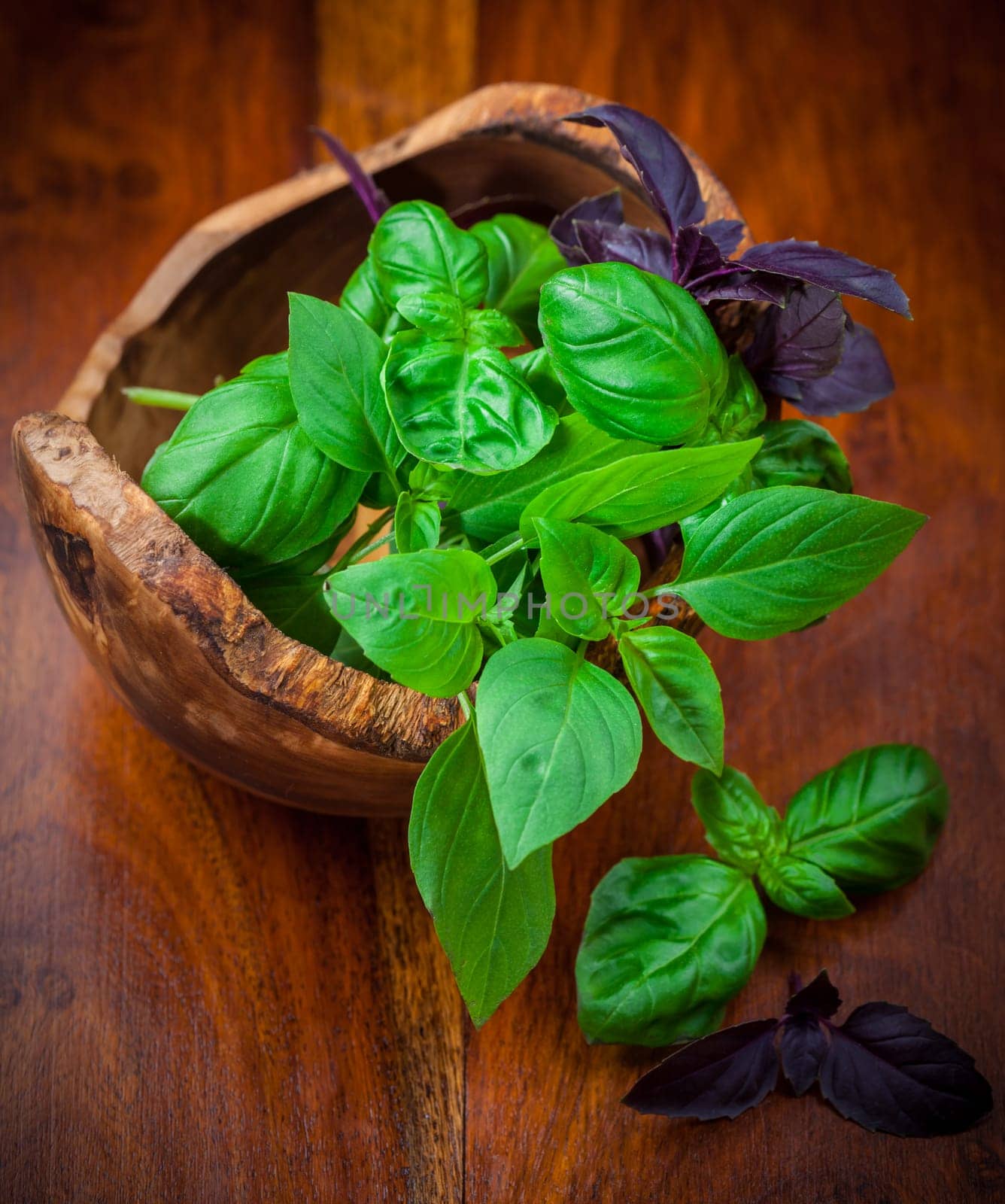 Different basil sorts in wooden bowl