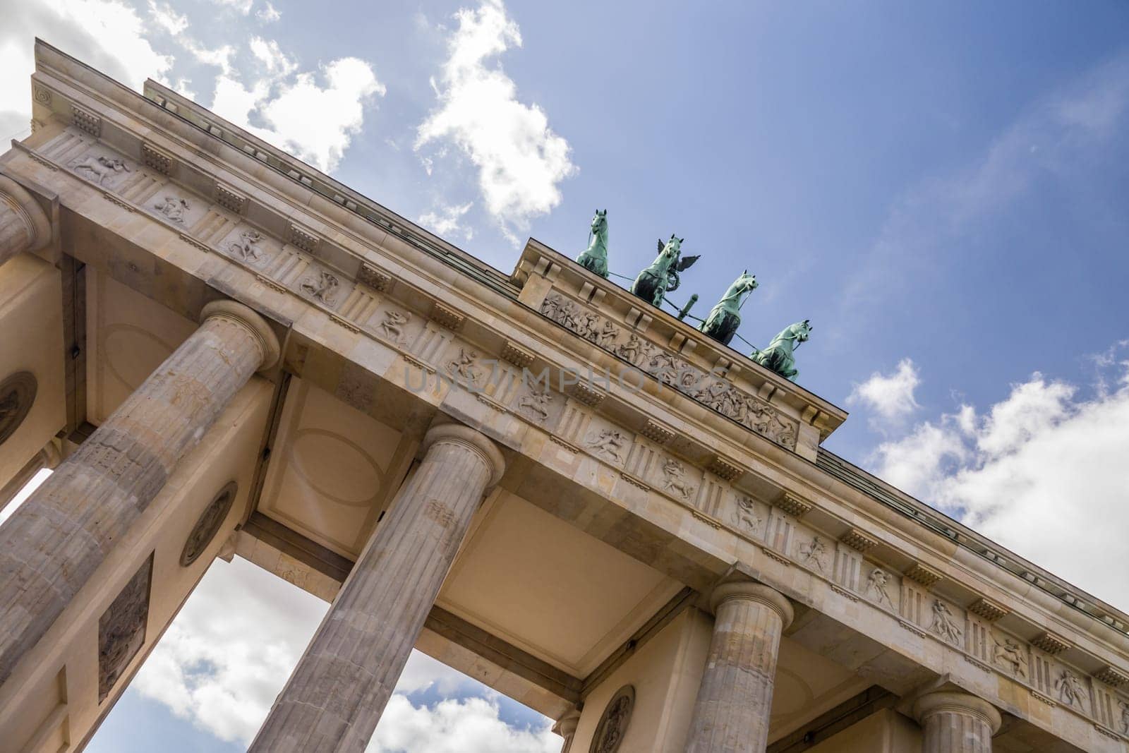 brandenburger tor in berlin with blue cloudy sky