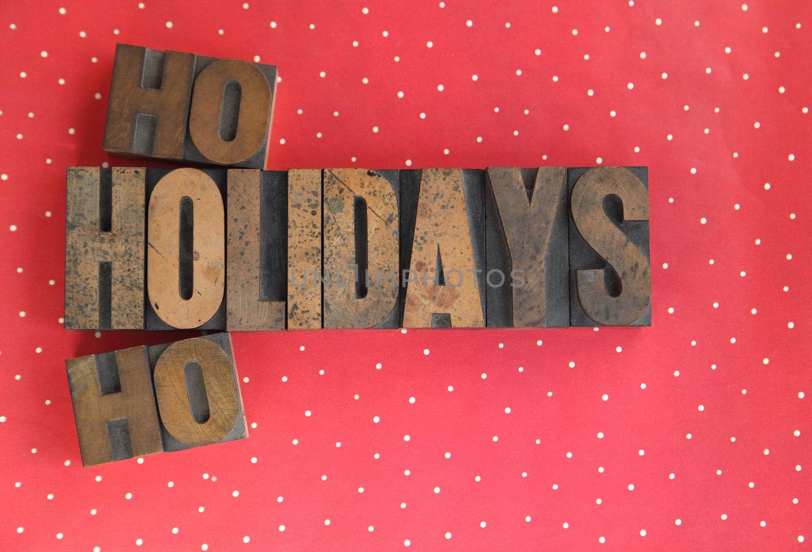 holidays ho ho words in old wood type on a polka dot background