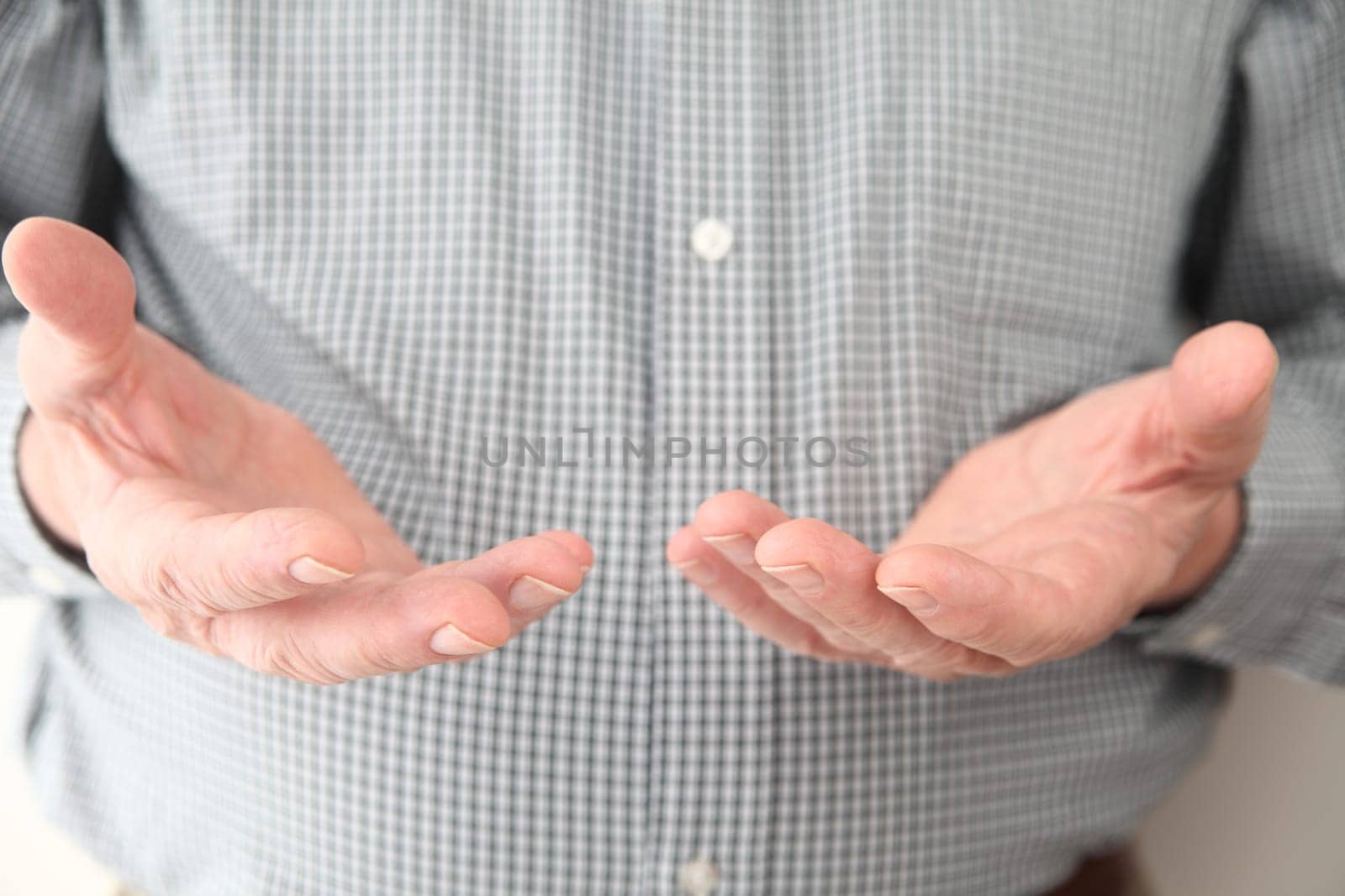 a man gestures with both hands