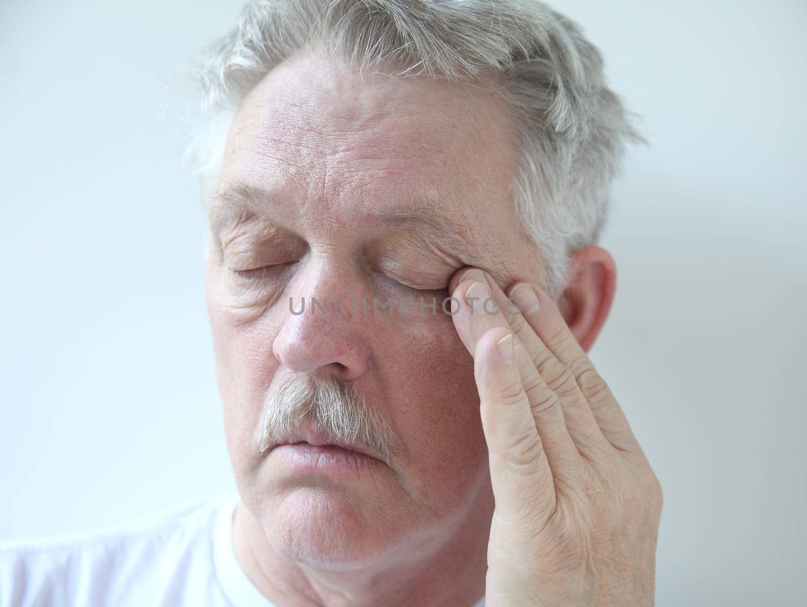 senior rubs the corner of his eye