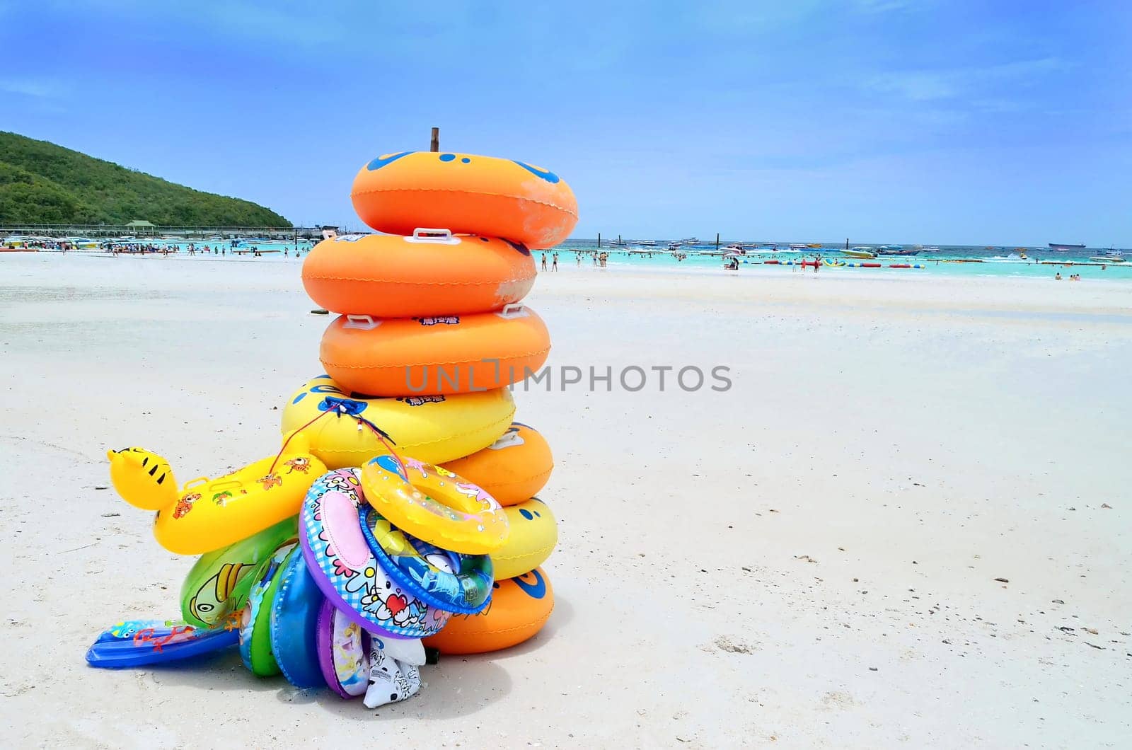 Stack of colorful swimming tubes on the beach