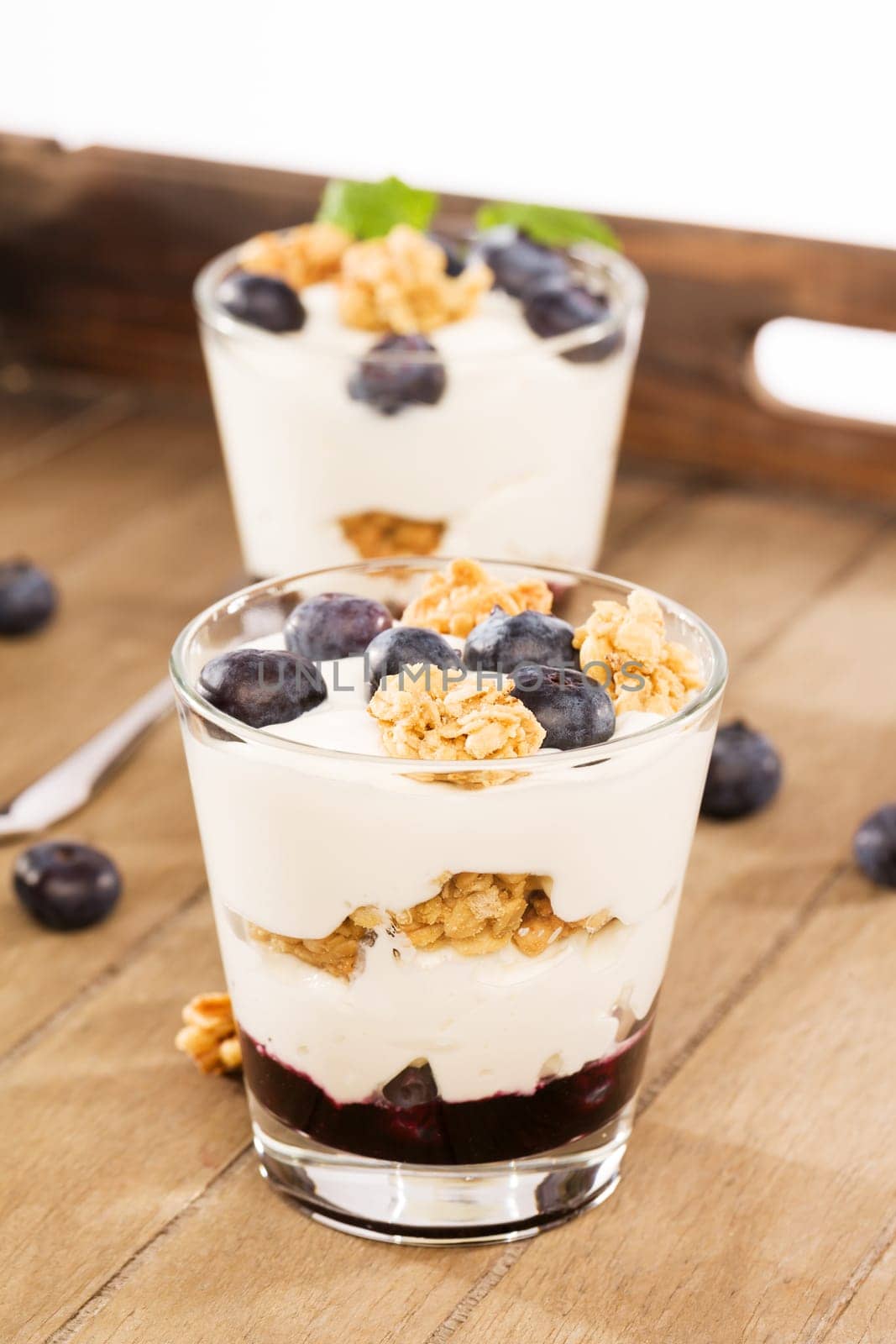Blueberries yogurt desserts on wood with blueberries