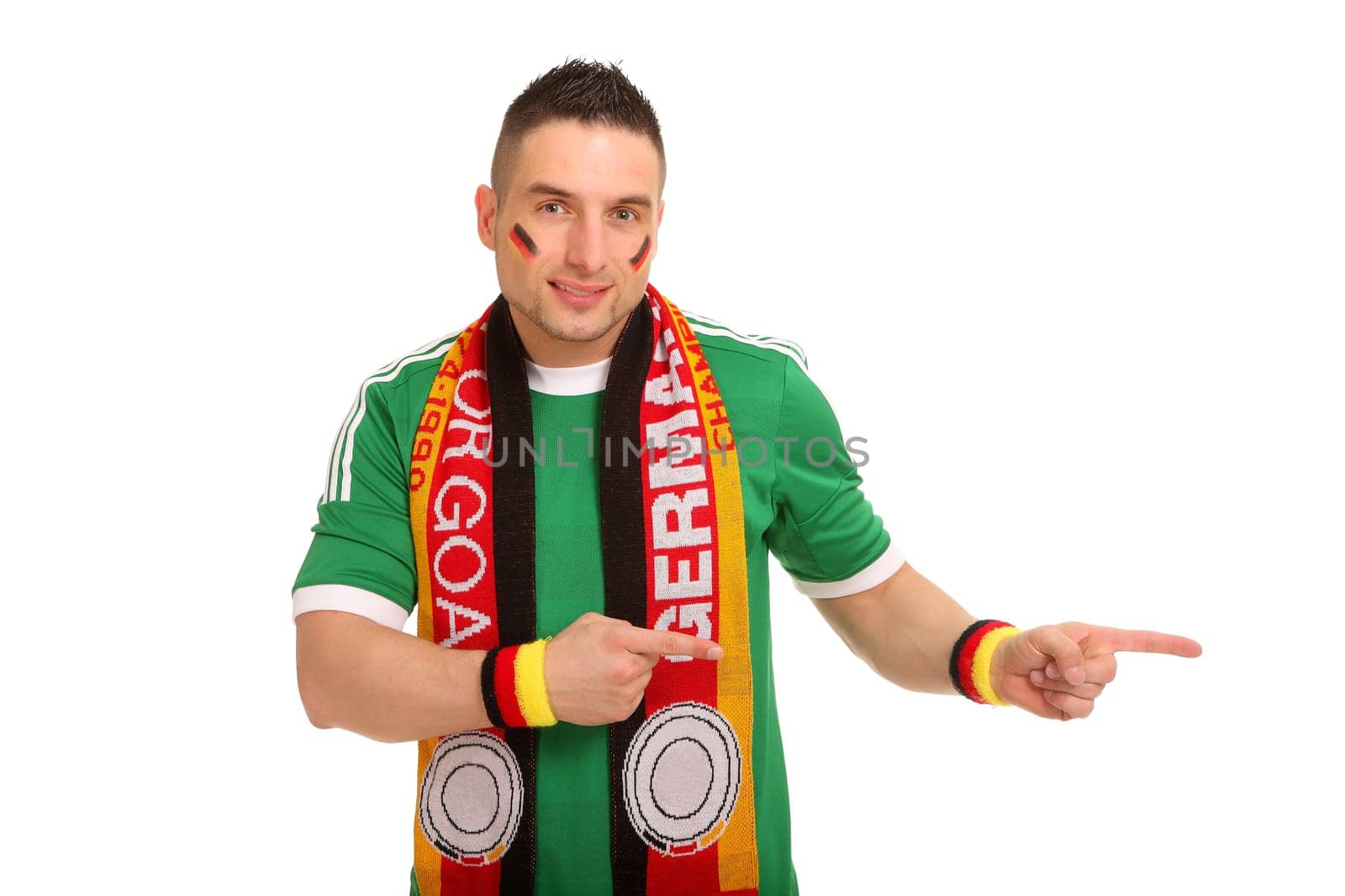 The photo shows a man dressed as a football fan of the national team. He points to the side.