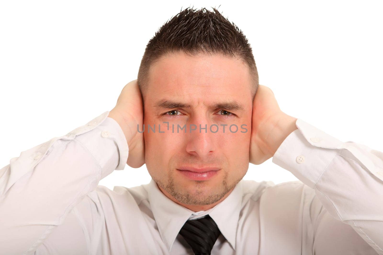 Portrait photo of a young man desperately covering his ears