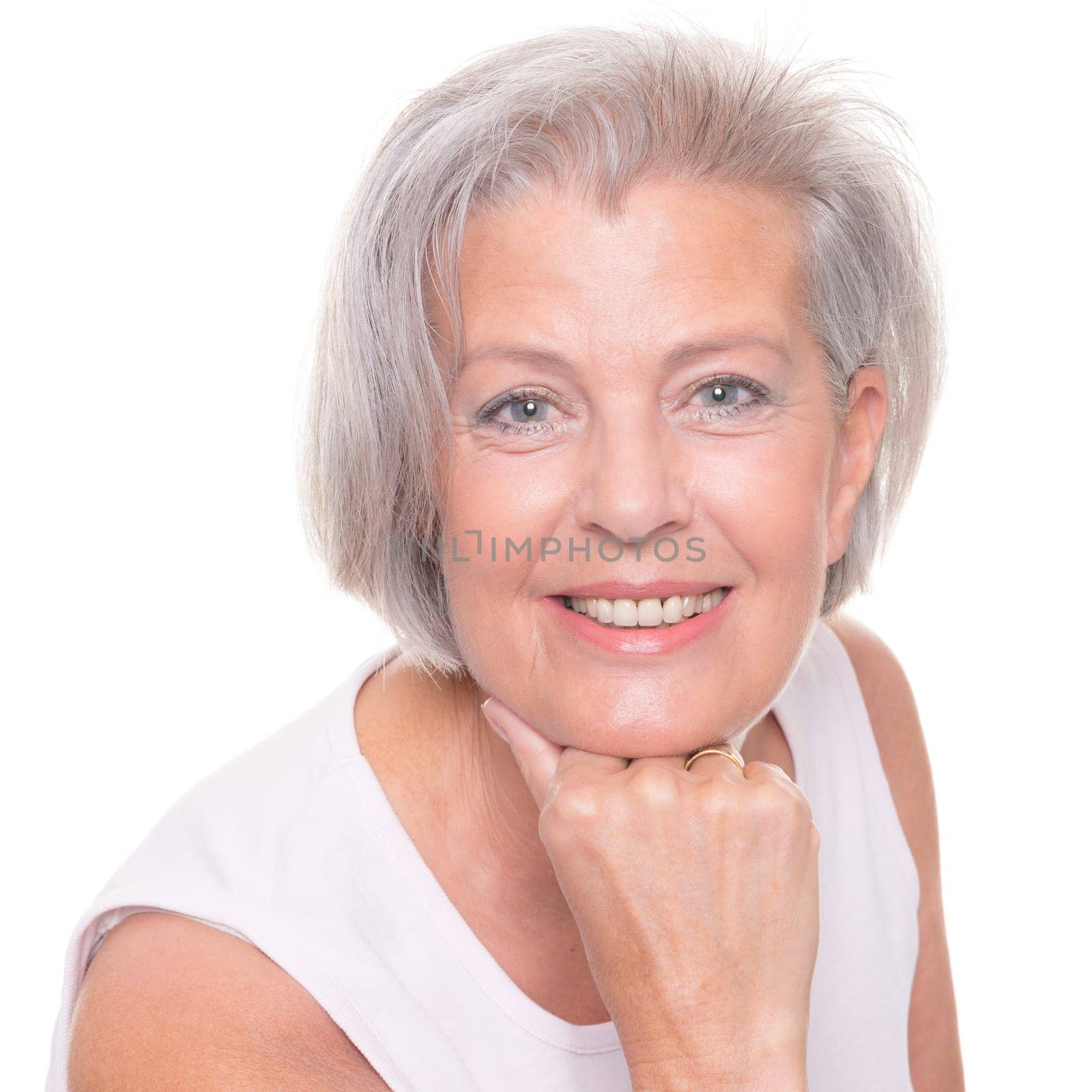 Smiling senior woman in front of white background