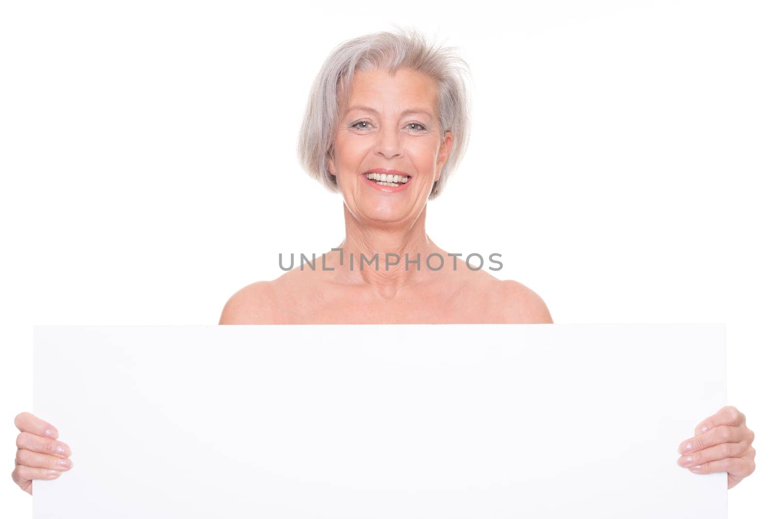 Senior woman holding billboard against white background