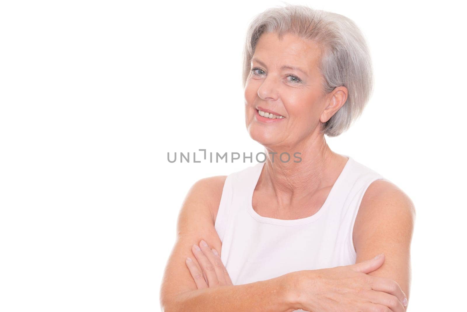 Smiling senior woman in front of white background