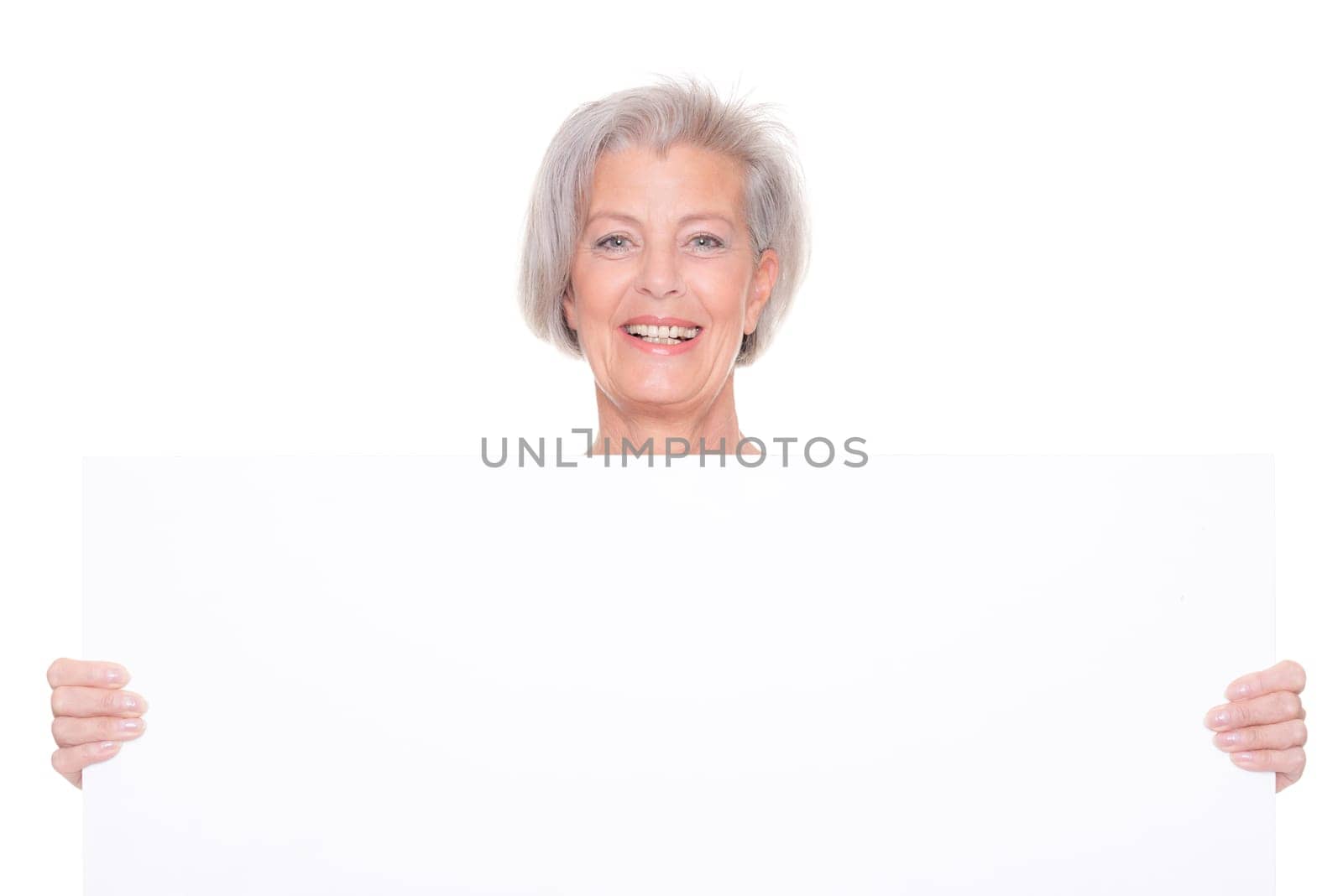 Senior woman holding billboard against white background
