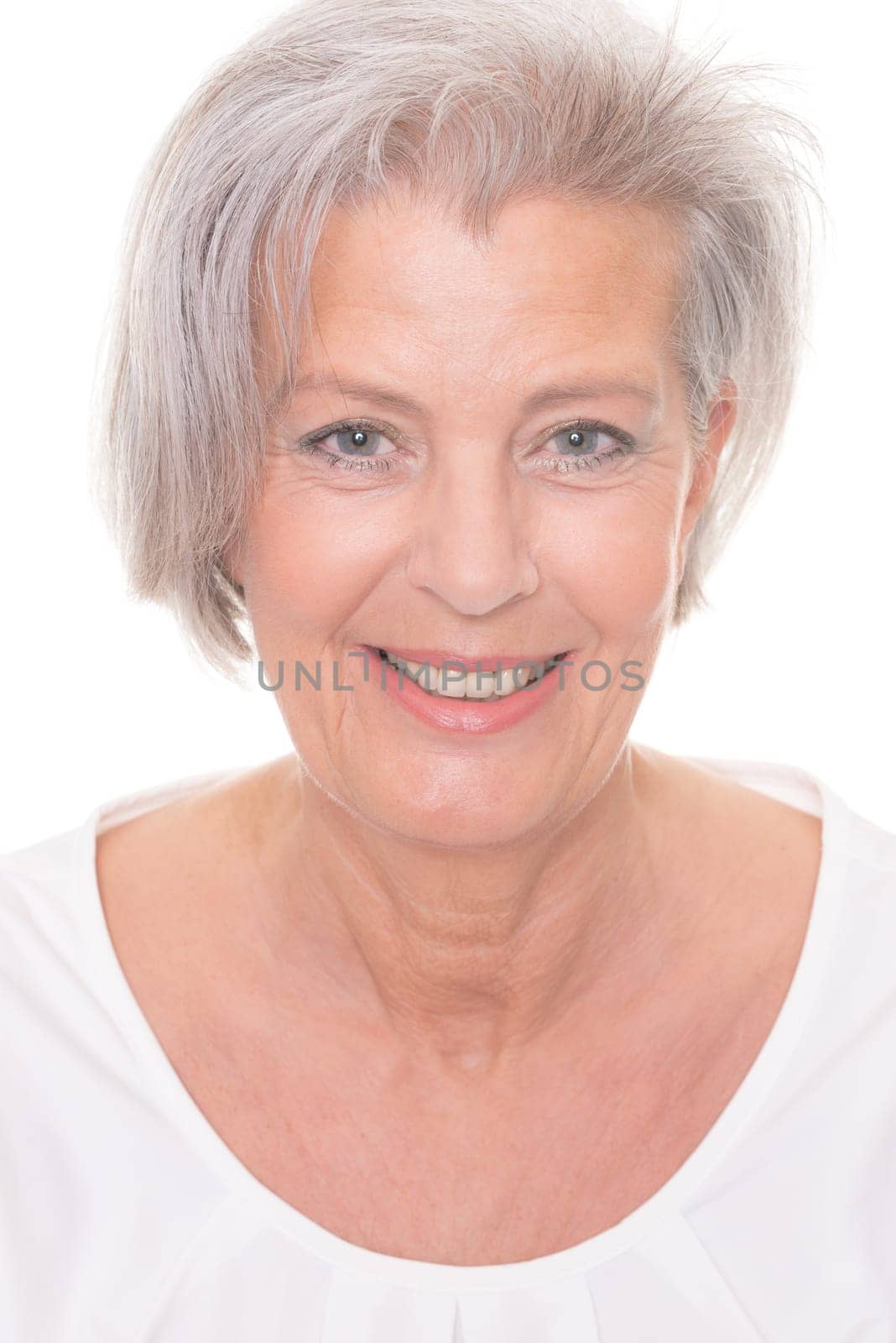Smiling senior woman in front of white background