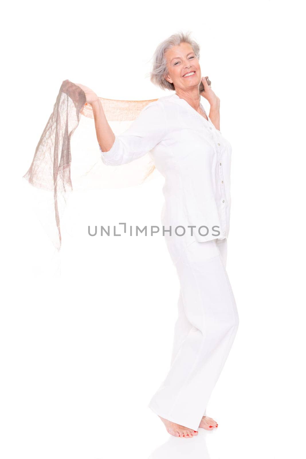 Happy senior woman with a cloth against a white background