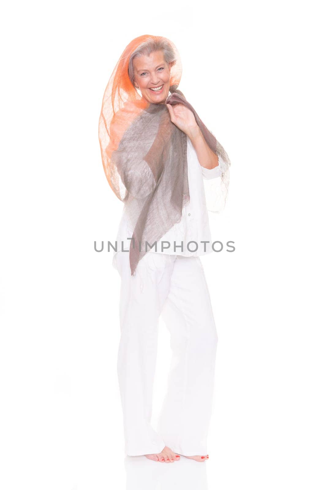 Happy senior woman with a cloth against a white background