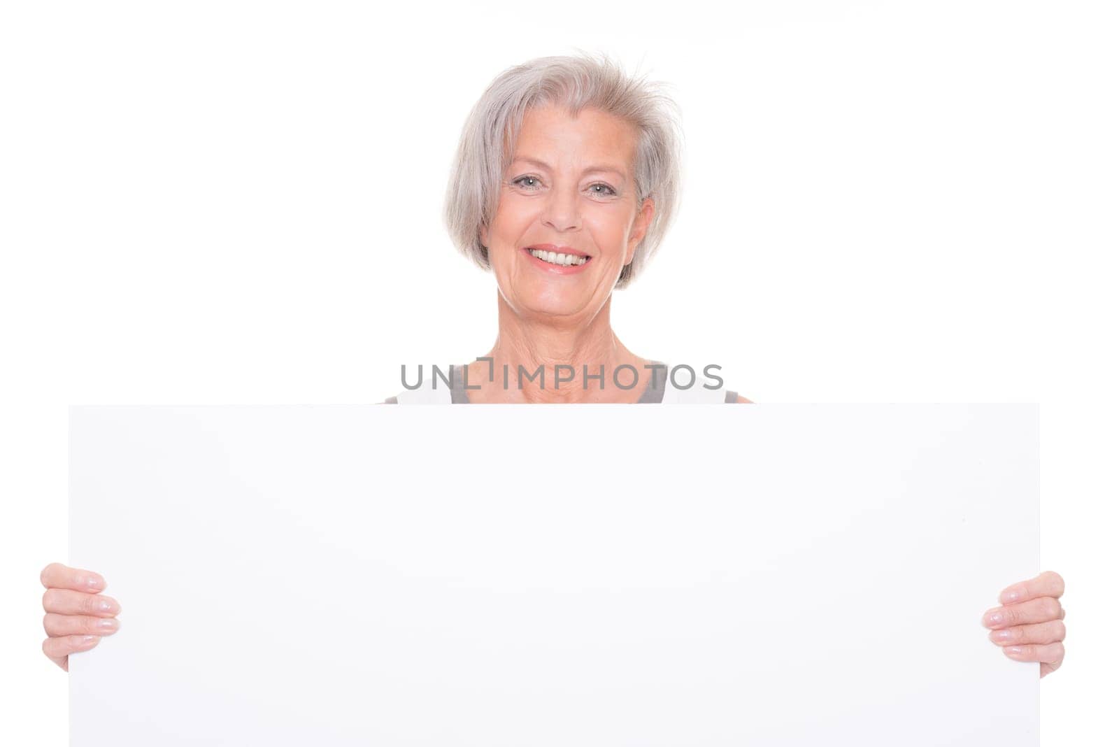 Senior woman holding billboard against white background