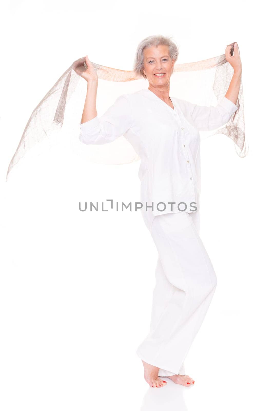 Happy senior woman with a cloth against a white background