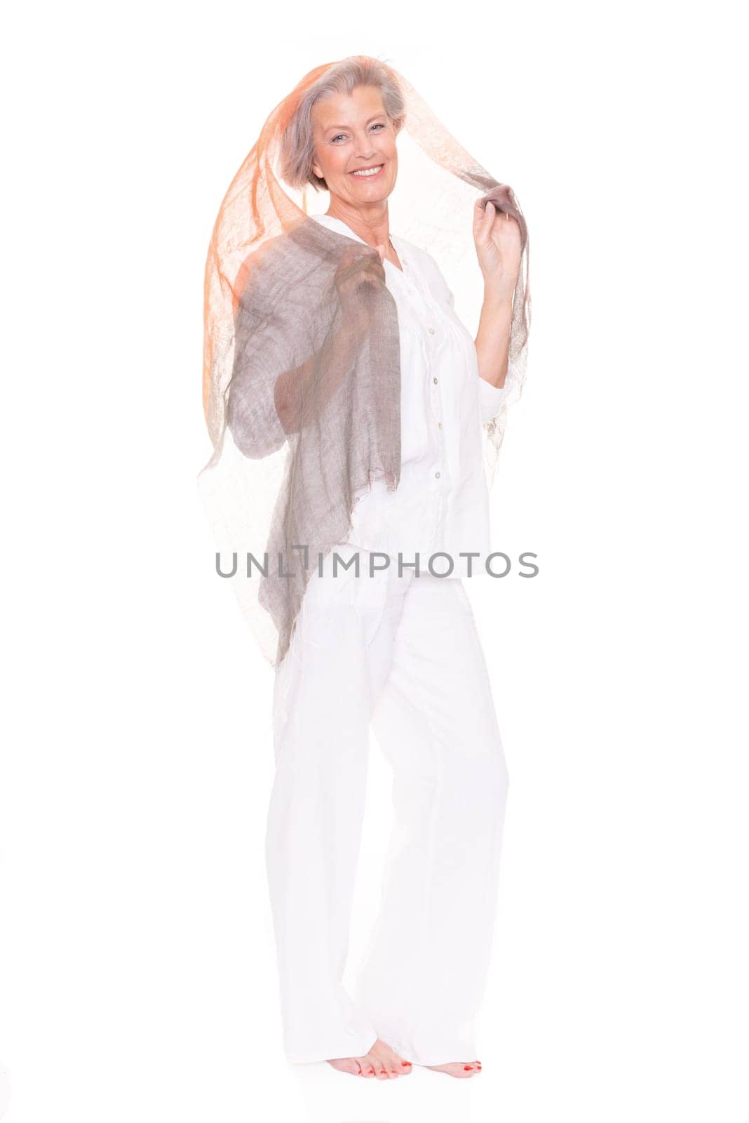 Happy senior woman with a cloth against a white background
