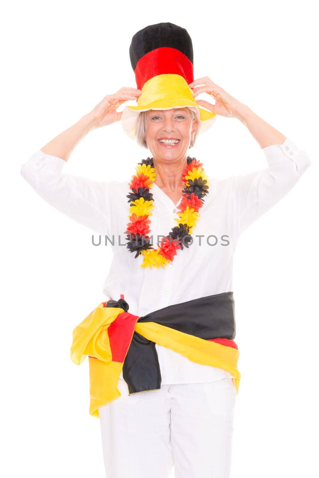 Senior woman as a German football fan in front of white background