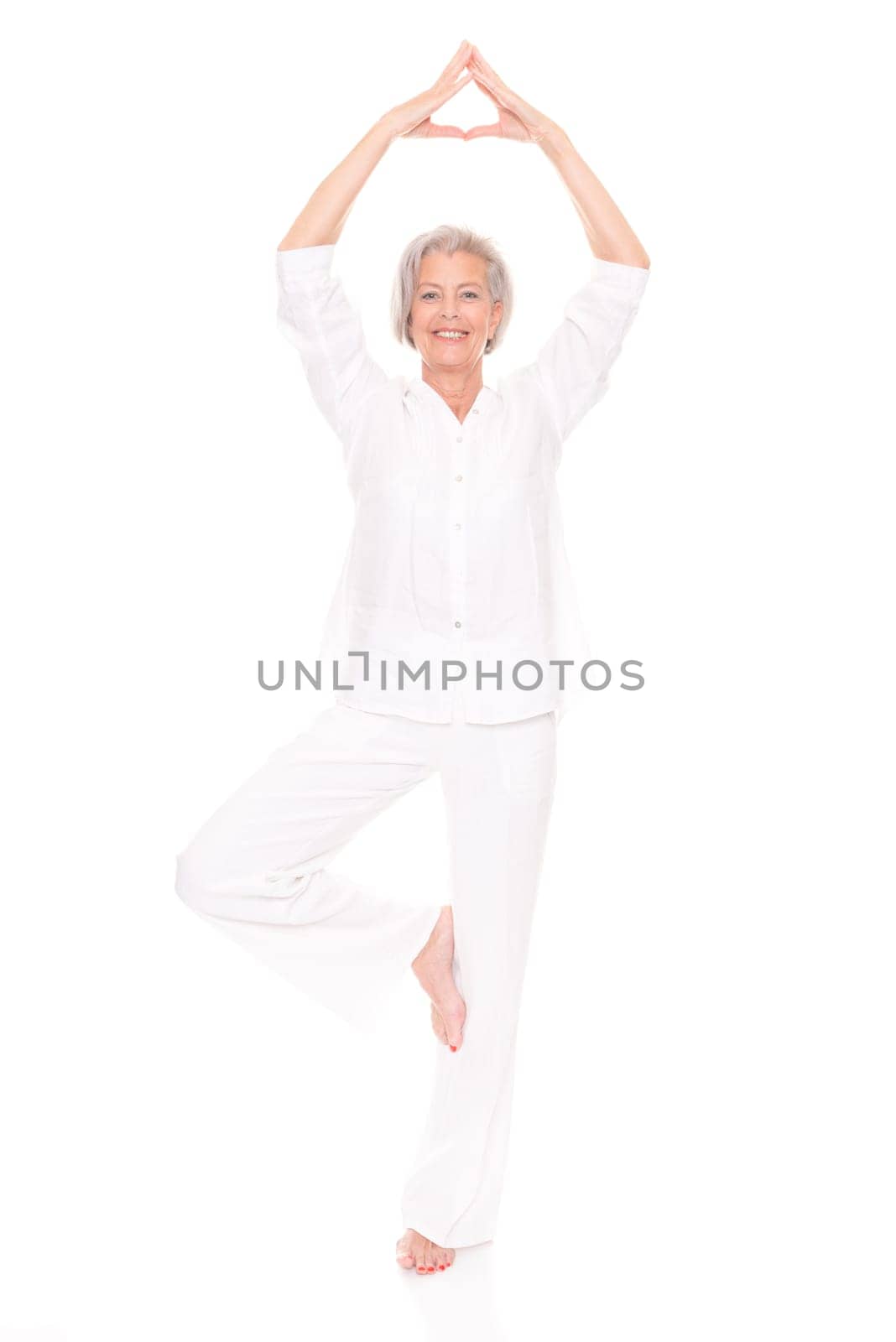 Full length shot of an elderly woman against a white background